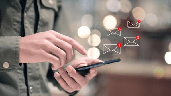 Person checking smartphone with new message notifications.