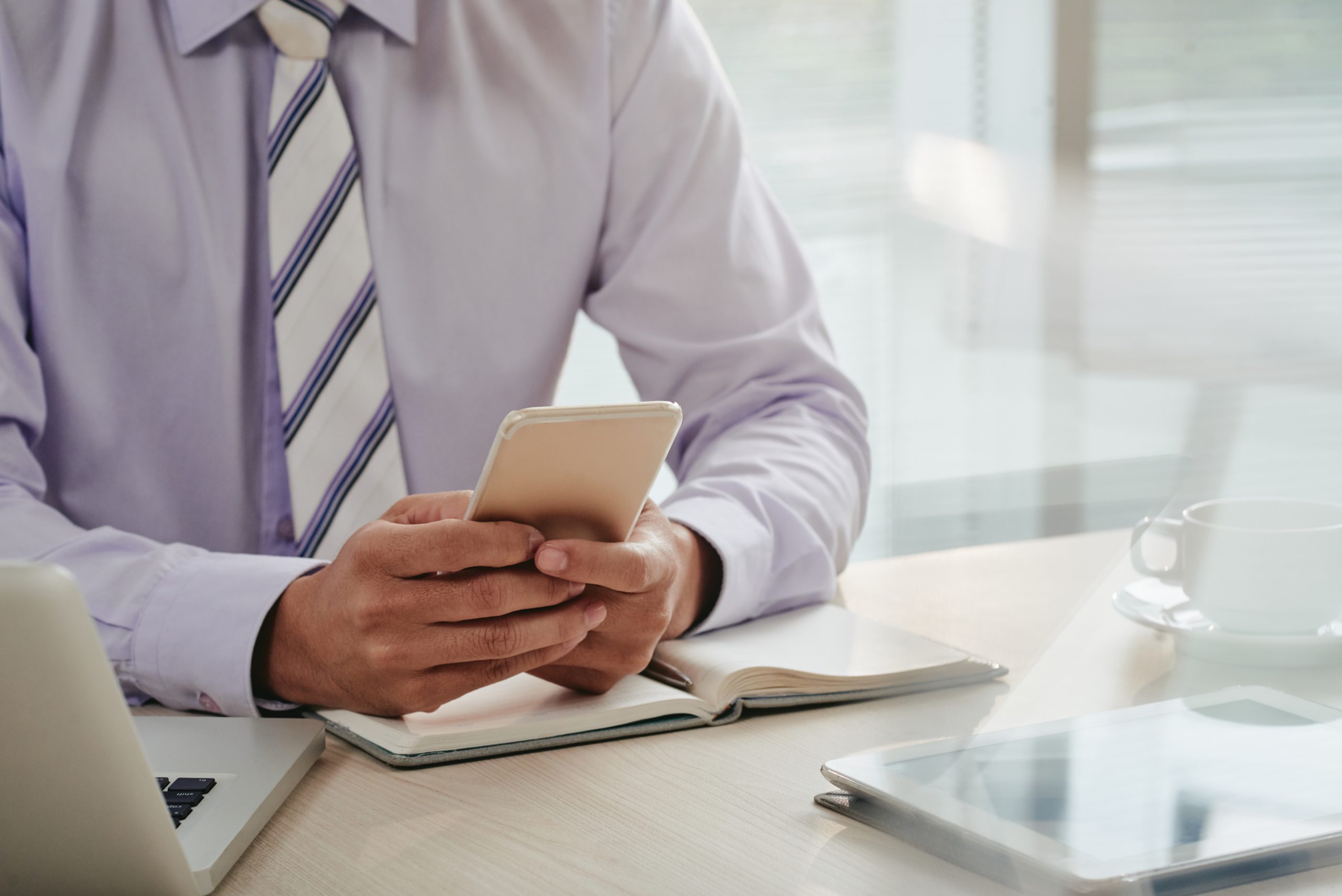 mid section man checking emails smartphone