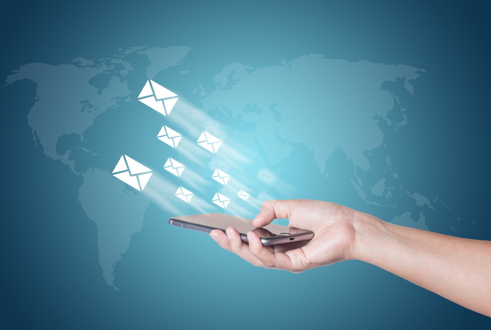 Hand holding a smartphone sending multiple messages across a global map background.
