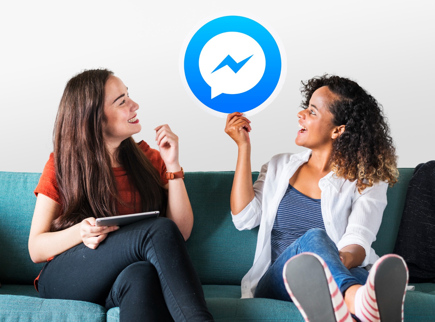 Two people chatting on a couch, representing instant messaging and real-time communication.
