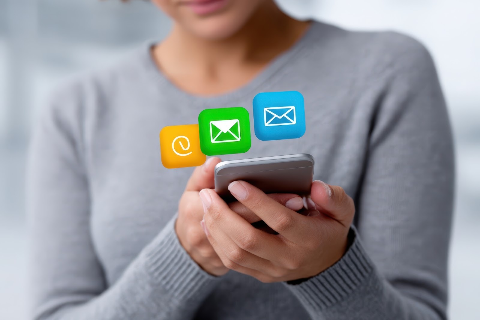 Person using a smartphone with email app.