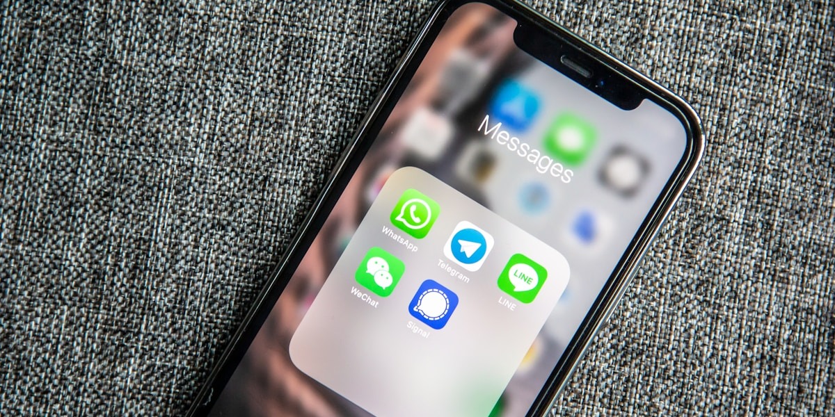 Smartphone screen showing messaging apps including WhatsApp, Telegram, WeChat, LINE, and Signal.