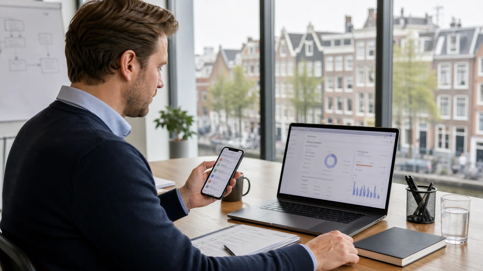 Netherlands marketing operations professional reviewing sender display, consent records, and SMS campaign setup on a laptop and mobile phone.