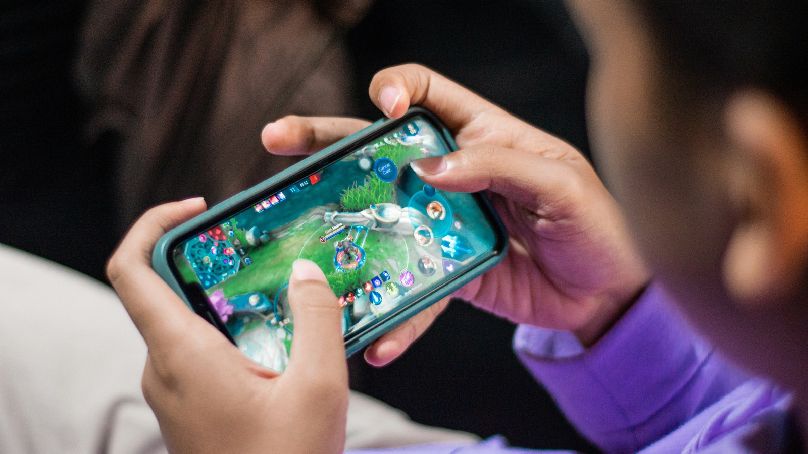 People using smartphones, illustrating player engagement and lifecycle messaging