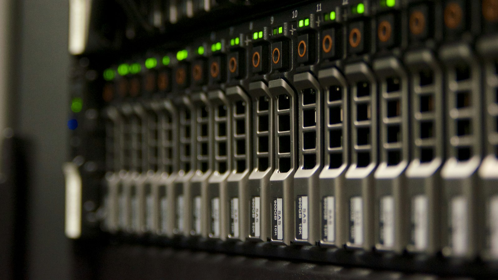 Close-up of a data centre server cabinet with rows of network modules and blinking green and amber status lights